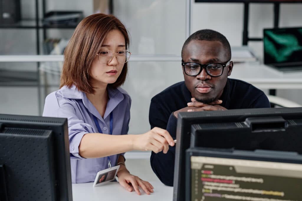 couple of developers working on computer together.jpg