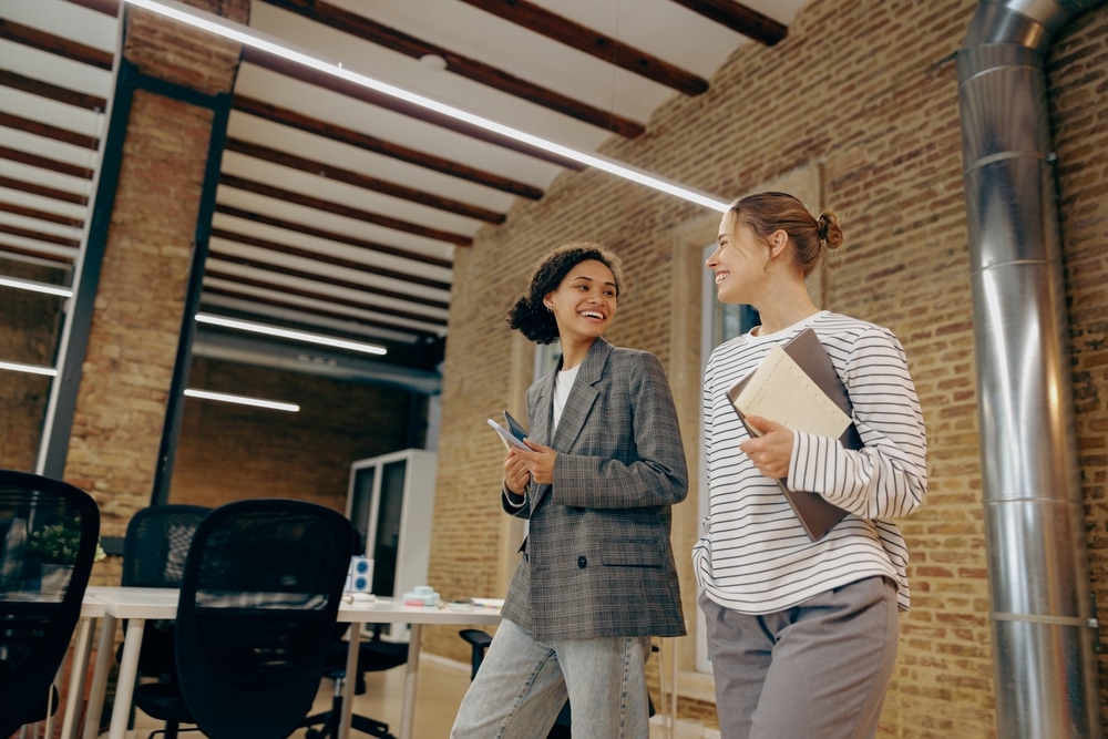 Smiling,Women,Colleagues,Speak,Laughing,Enjoy,Leisure,Time,At,Workplace.